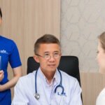 Doctor consulting with patient and assistant